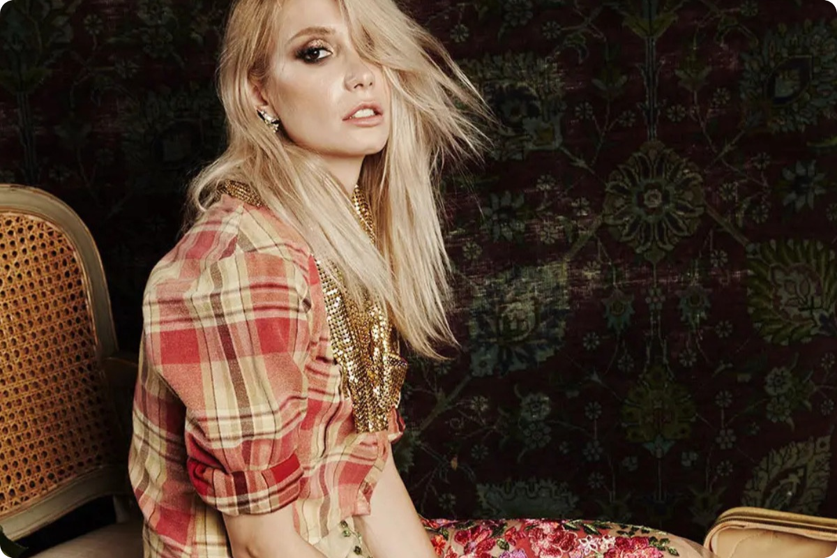 Woman in a plaid shirt sitting on a patterned couch