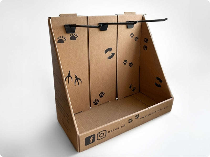 Cardboard POS stand with paw prints on a white background