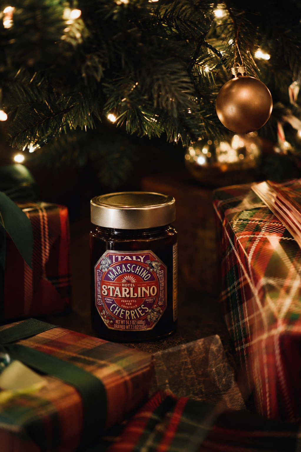 Hotel Starlino jar among gifts beneath a Christmas tree