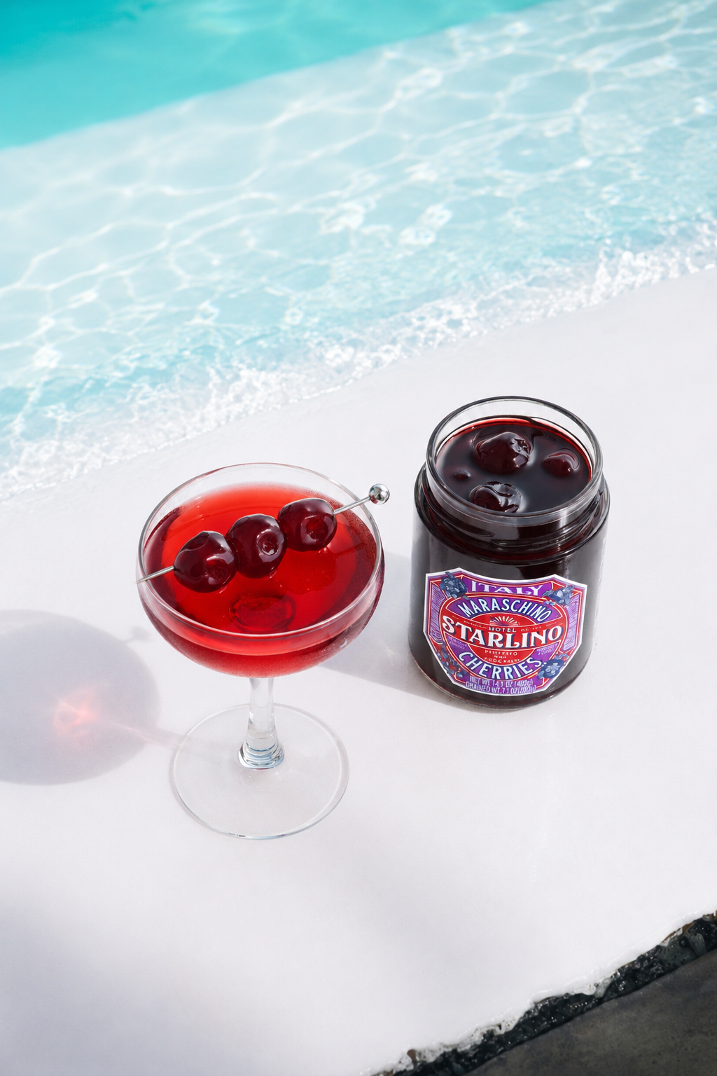 Hotel Starlino cherries and a cocktail beside a swimming pool