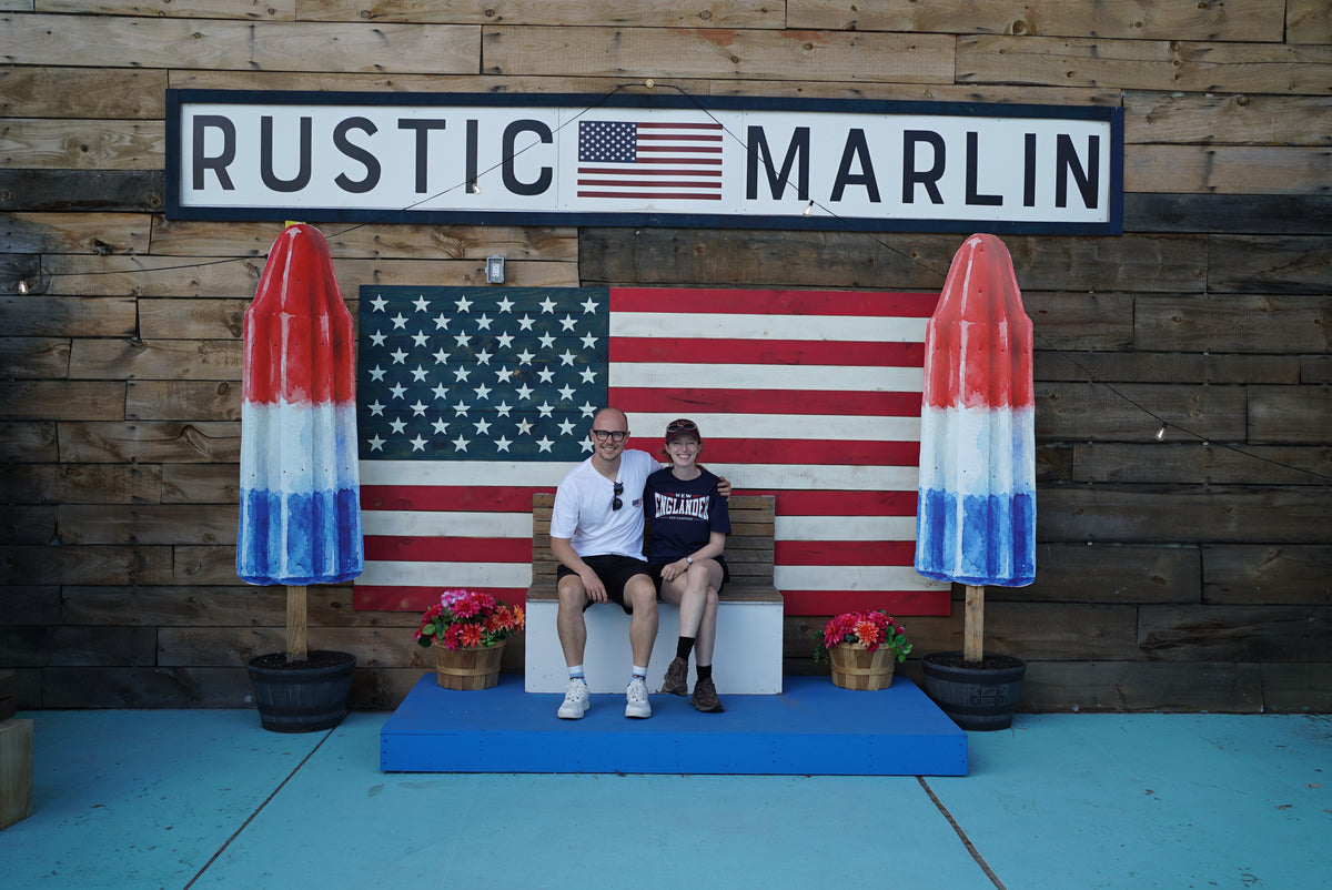 Candid Founders together beneath the Rustic Marlin sign