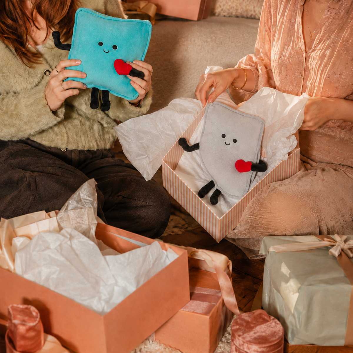Artwork showing two state plush gifts being unwrapped
